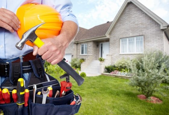 Hands of Handyman with a tool belt.